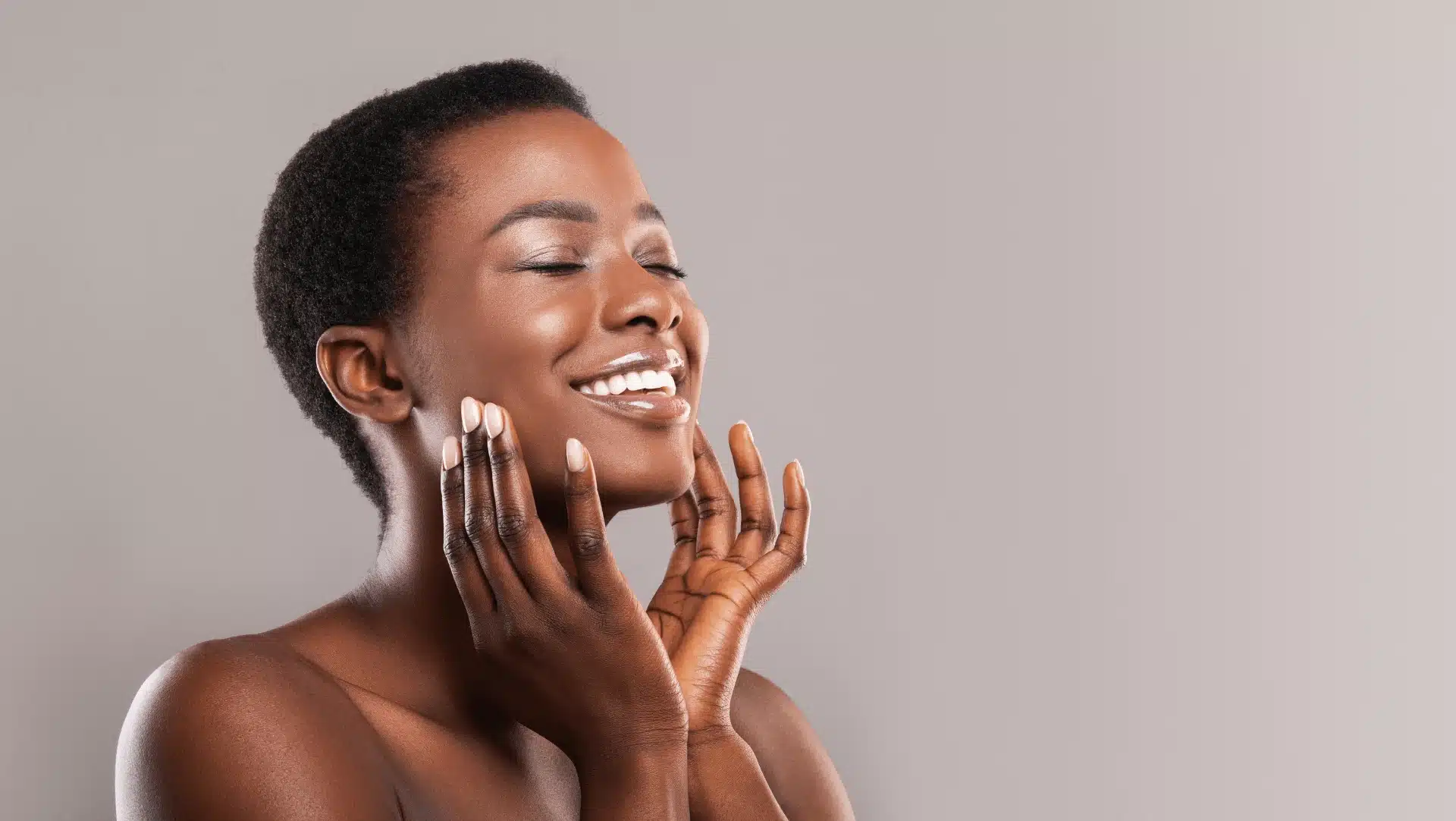 A smiling dermatology patient with healthy, glowing skin