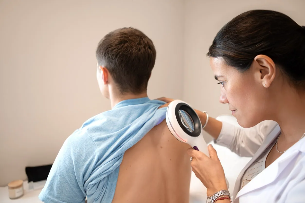 A dermatologist examining a patient's skin