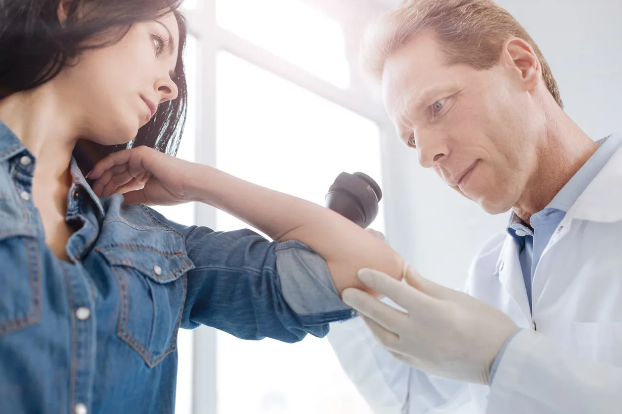 A dermatologist examining a patient