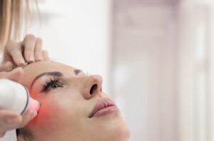 A woman receiving treatment from a dermatology provider