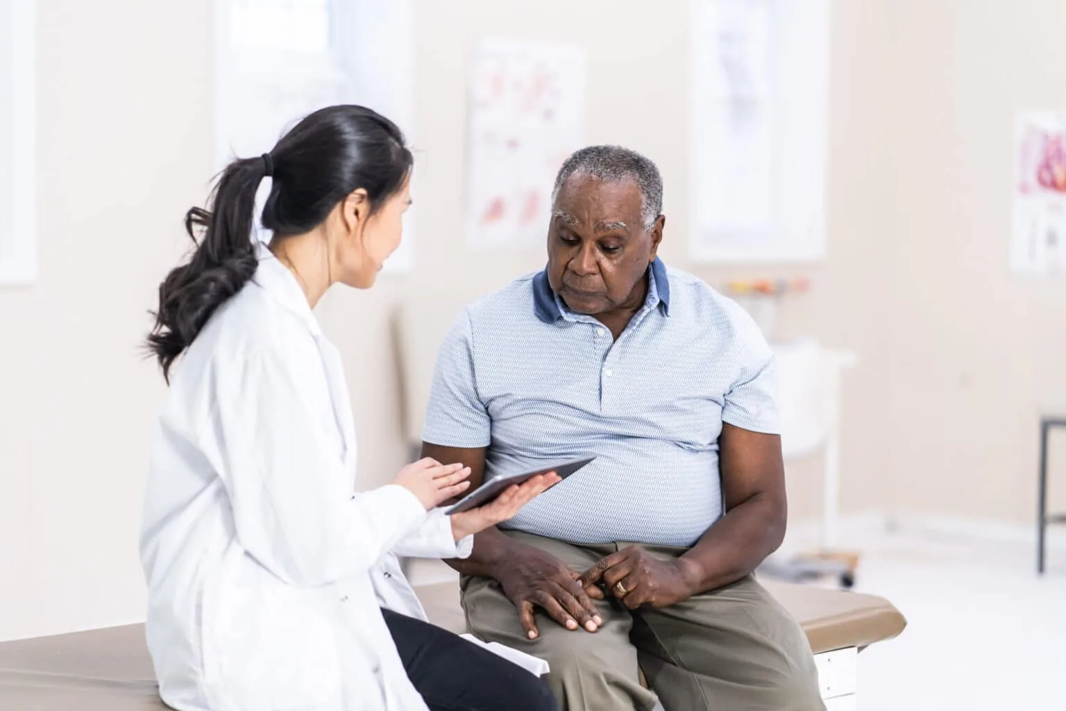 Dermatologist reviewing a patient's medical information during a skin consultation