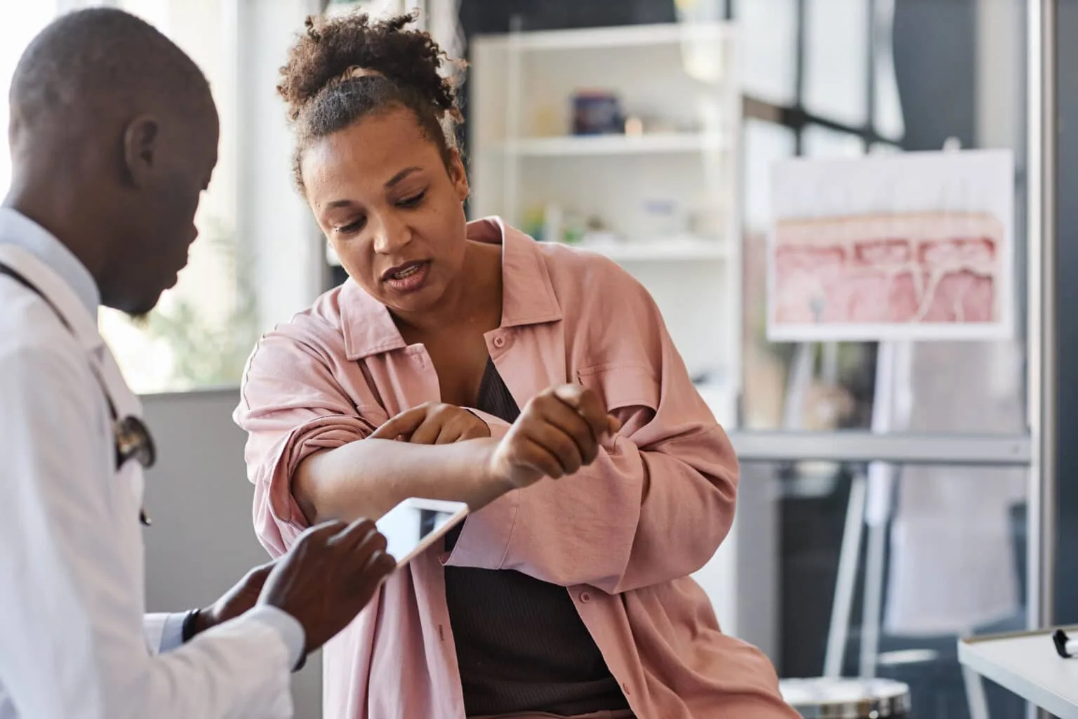 Dermatologist discussing a patient's skin condition during a consultation