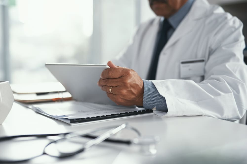 Dermatologist reviewing patient insurance and medical paperwork