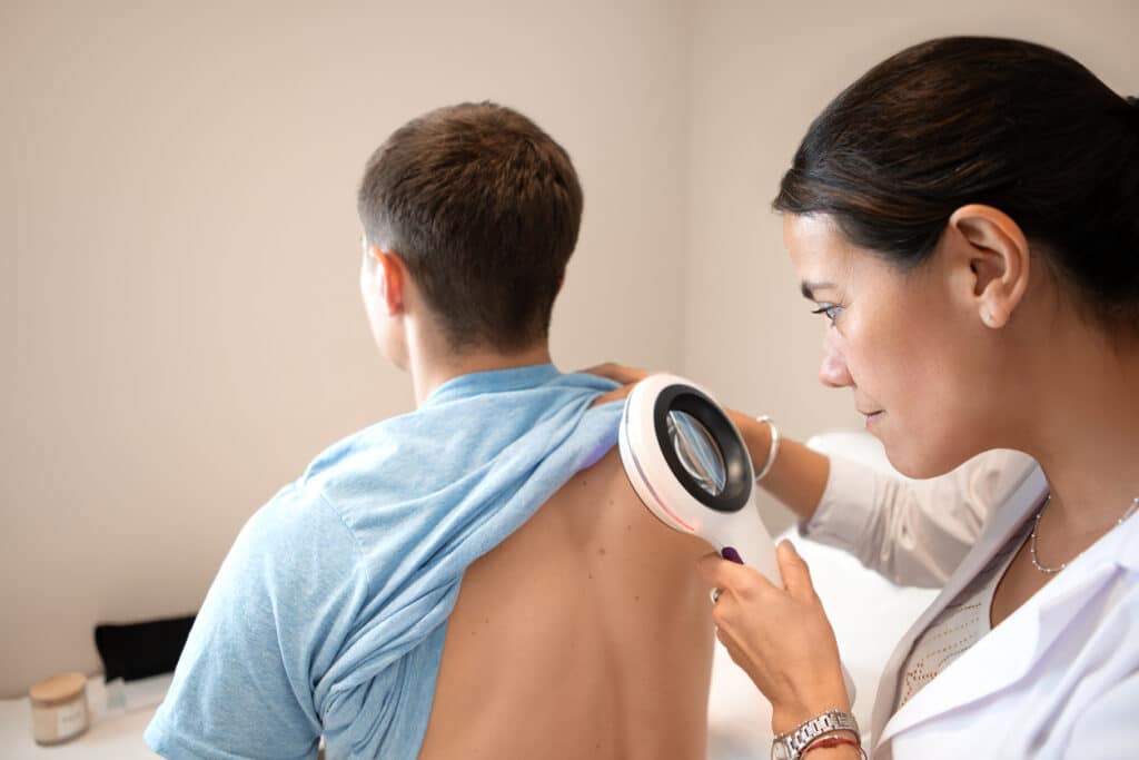 A dermatologist examining a patient's skin